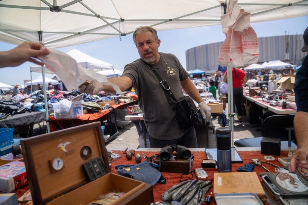 San Diego Kobe Swap Meet vendor Wali Amin, a migrant from India, who is rebuilding his business after the 2008 recession