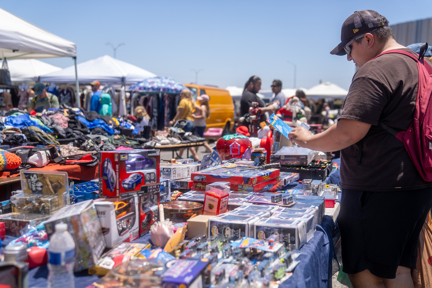 Kobe Swap Meet shoppers browsing Wali Amin's antiques at Pechanga Arena in San Diego