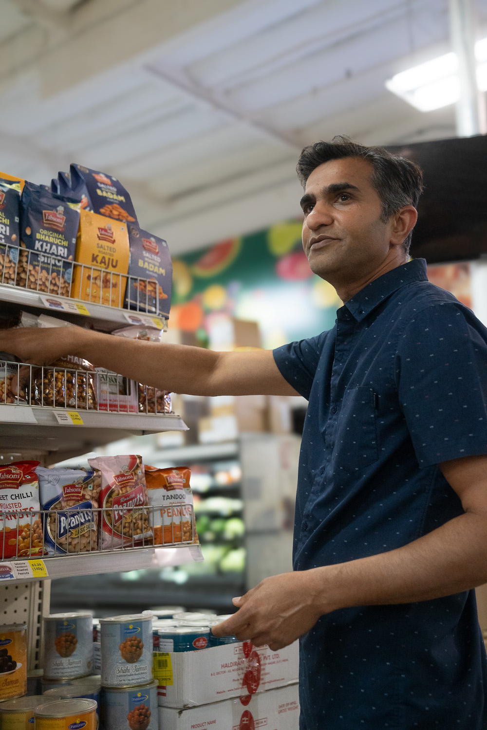 Interior of San Diego cash & carry international grocery store featuring Nitin Patel who founded Akshar Cash and Carry 10 years ago in Miramar