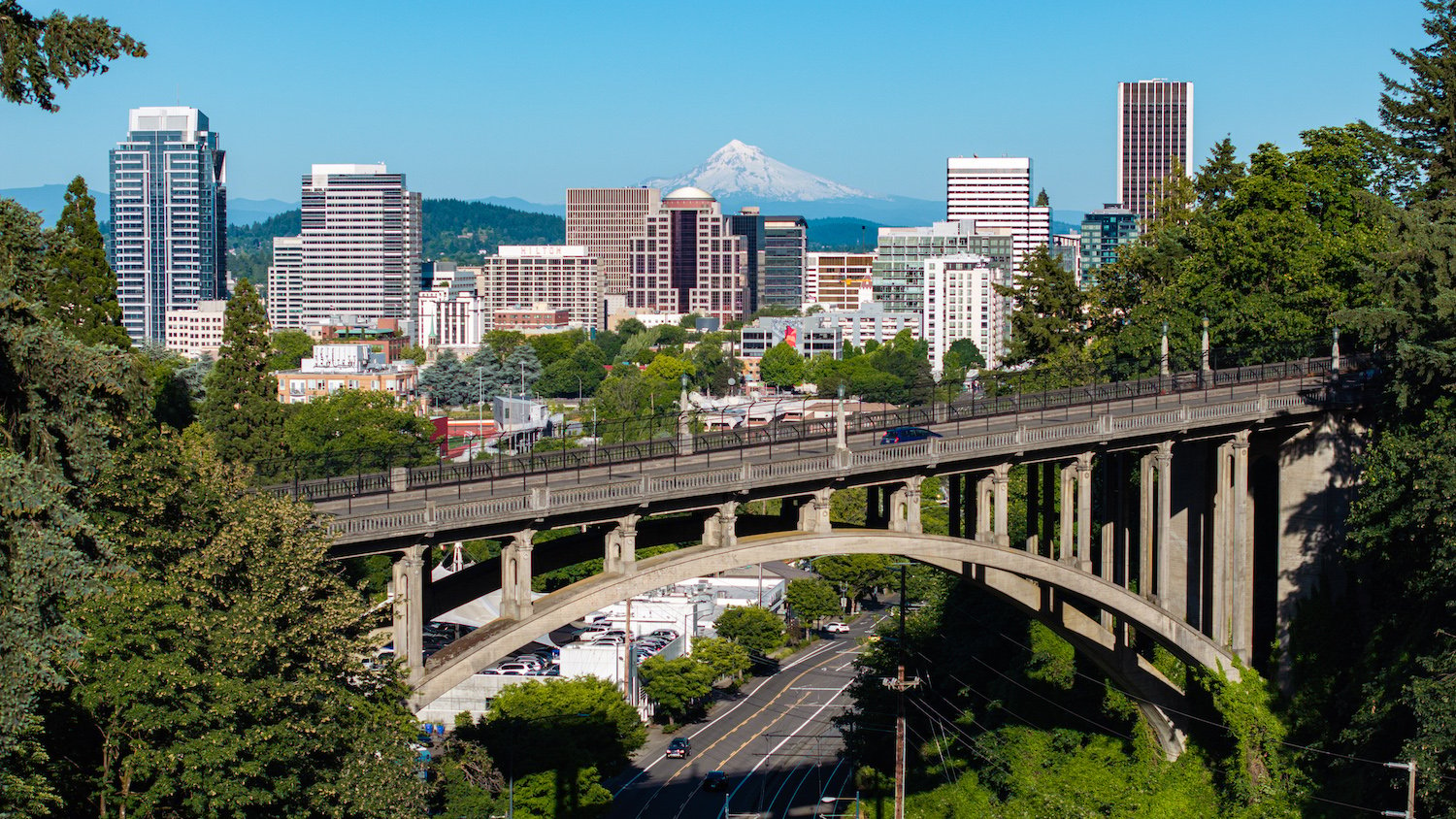 Portland, Oregon landscape featuring a bridge, the city, and Mt. Hood in the background