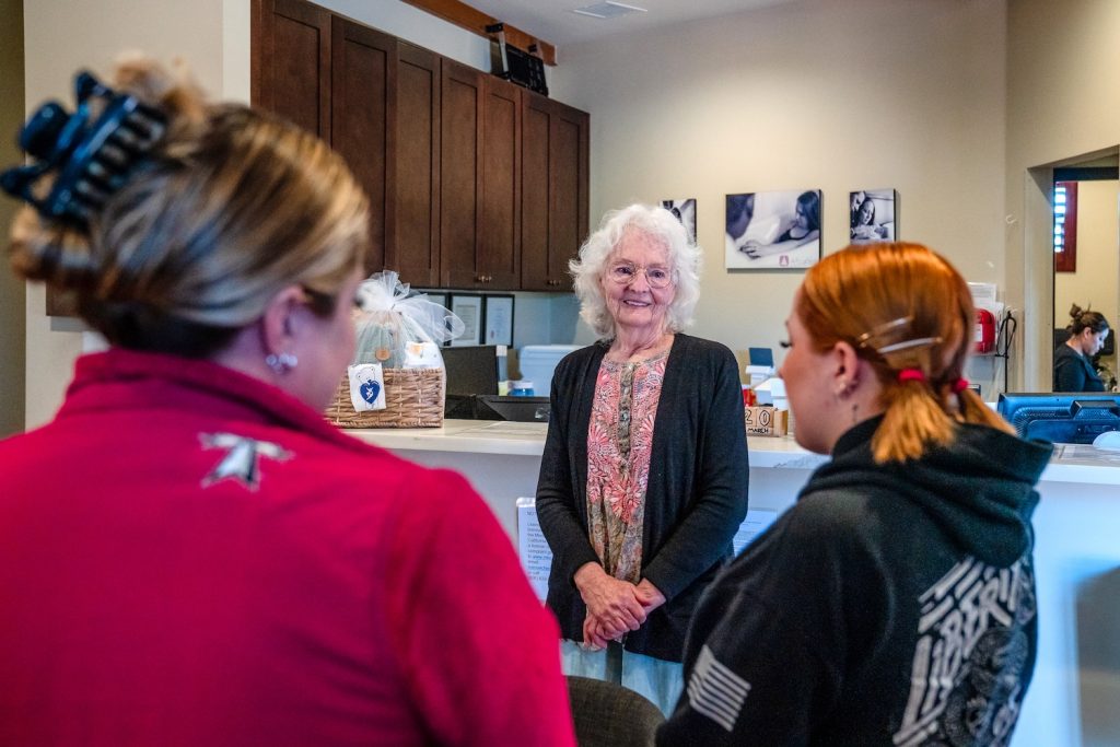 Founder Roberta Frank, center, talks to Ellary Alonso, right, 18 years old and twenty-one weeks pregnant, and her mom Hannah Fraley, left, at the Best Start Birthing Center in San Diego on March 20, 2024. Fraley had two of her kids at the center. Photo by Ariana Drehsler for CalMatters