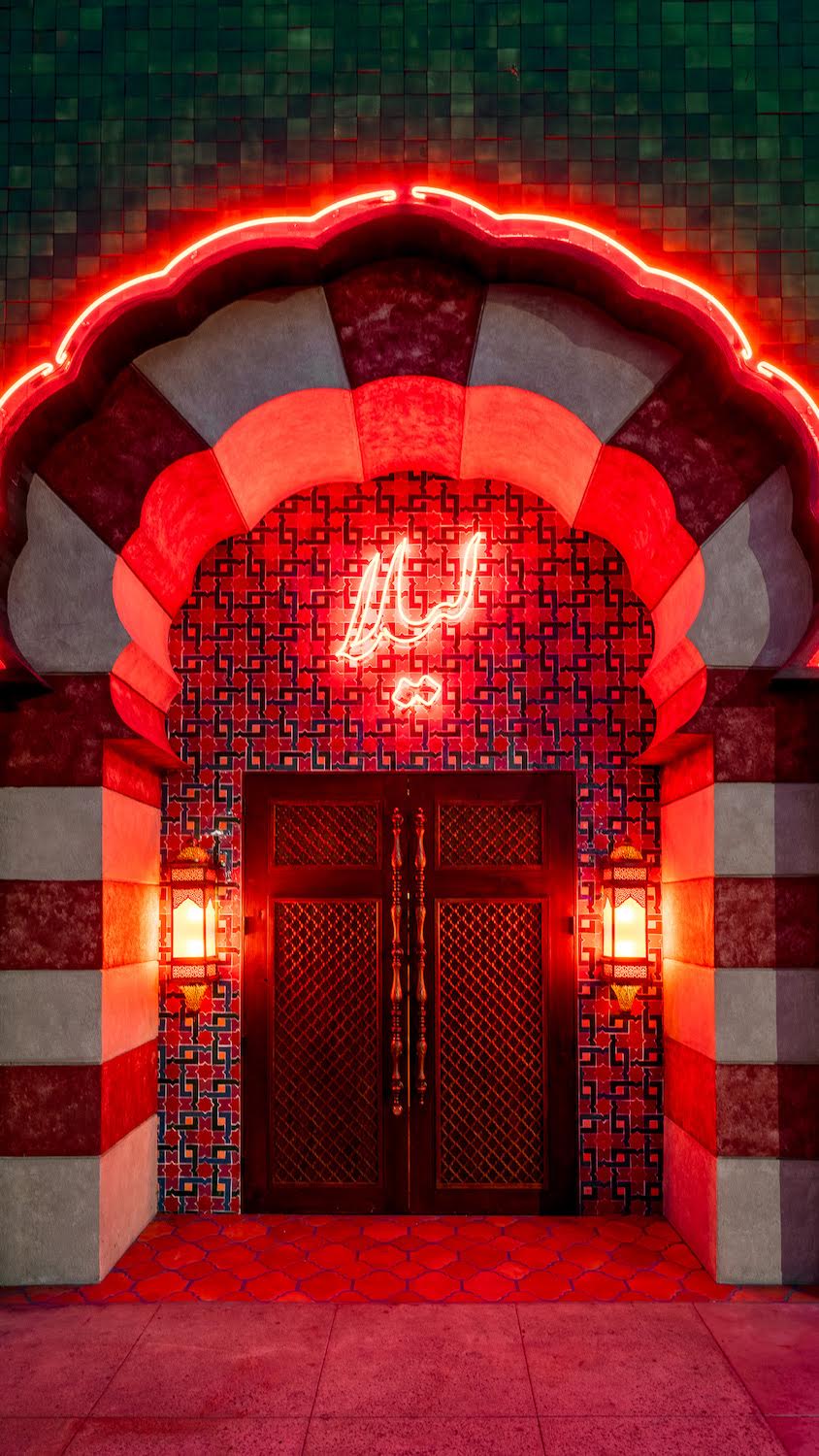 Front door with neon sign at San Diego Persian restaurant Leila