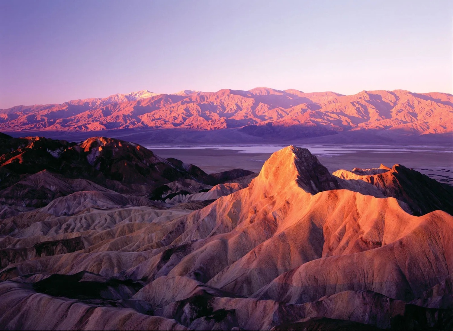 Guide to visiting California's national parks featuring  Death Valley National Park at sunset