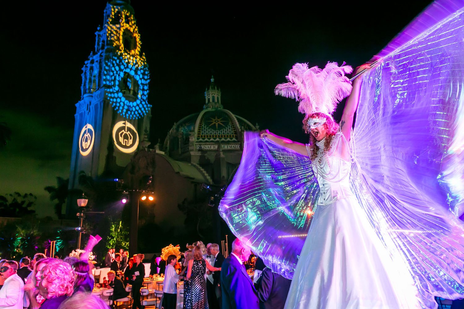 Old Globe's 2024 Gala Black and White Masquerade at Balboa Park, San Diego featuring a performer infront of El Prado