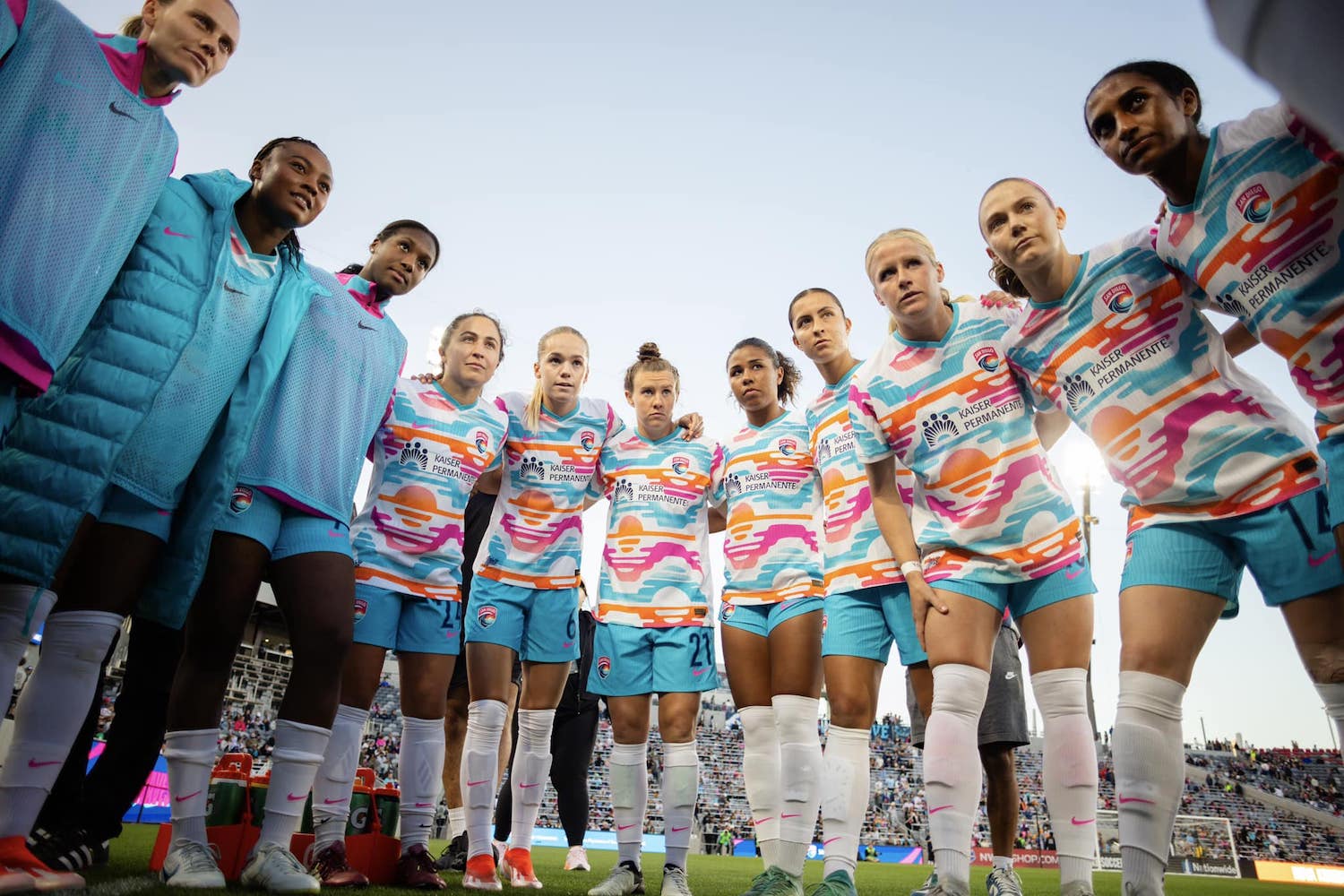 San Diego Wave FC soccer players huddled before a game during the 2024 NWLS season at Snapdragon Stadium