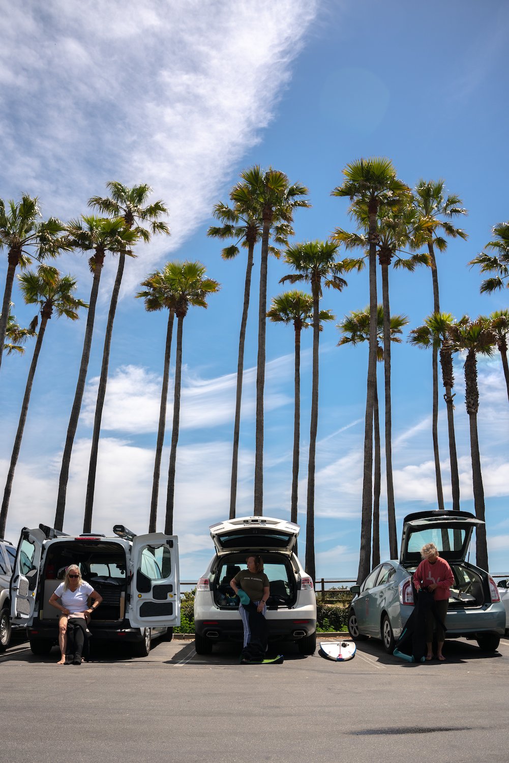 Women over-50 surfers at Santa Brabara's Wahine Kai Surf Club getting their wetsuits on at Campus Point on UCSB's campus