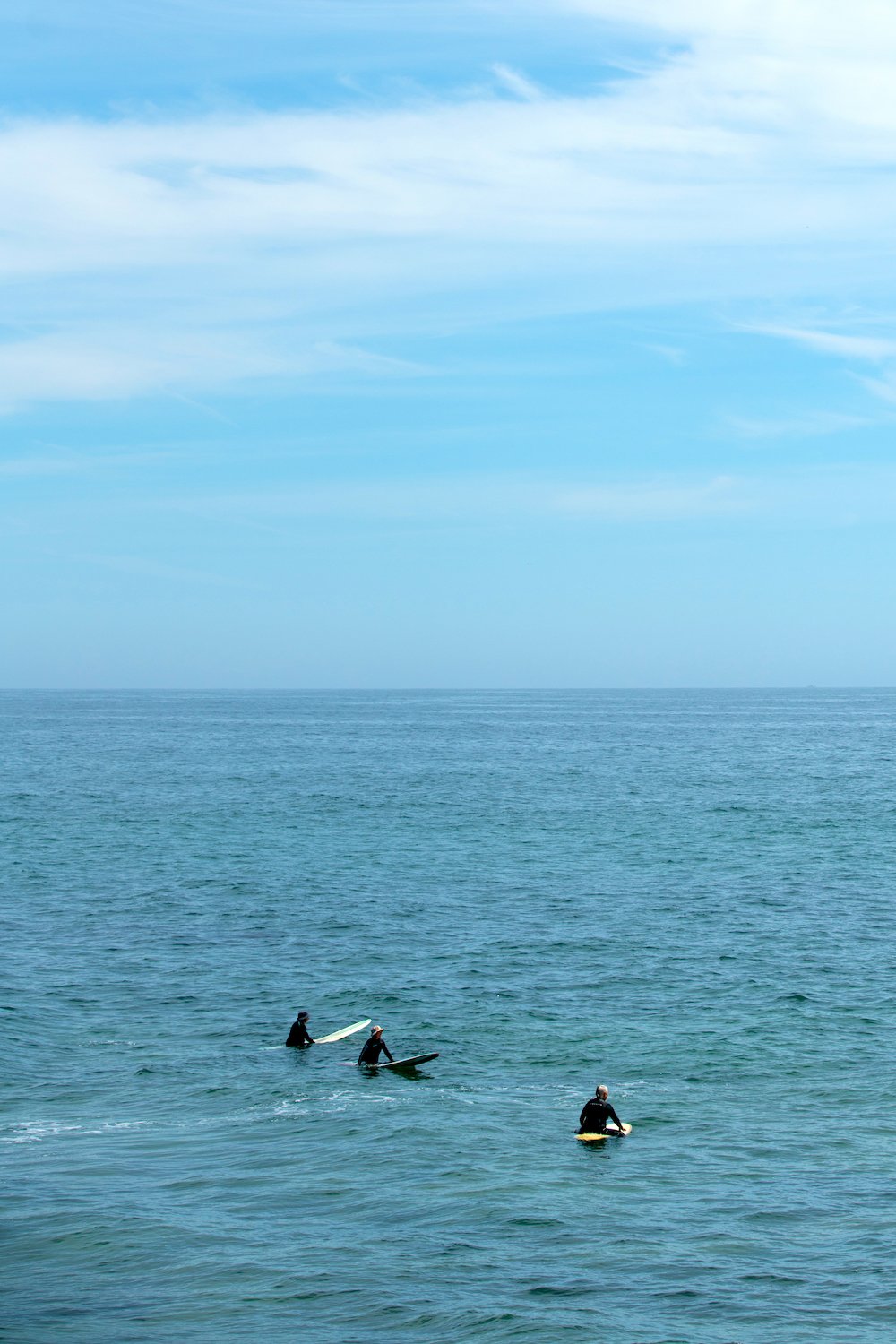 Women over-50 surfers at Santa Brabara's Wahine Kai Surf Club in the lineup at Campus Point surf spot