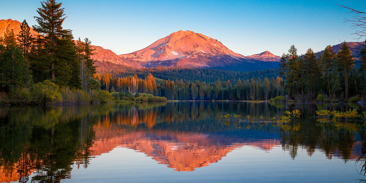 Guide to visiting California's national parks featuring Lassen Volcanic National Park and a lake