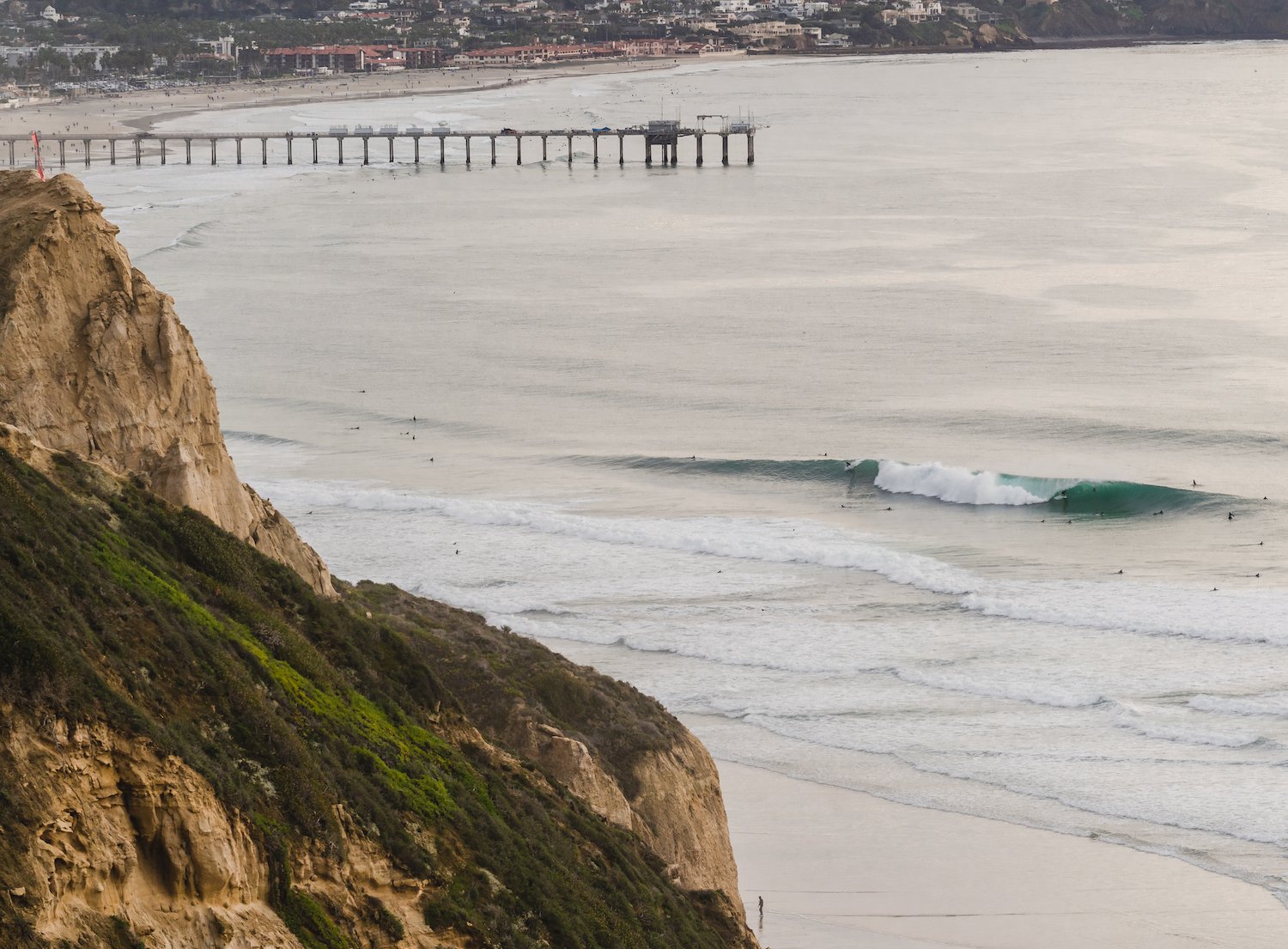 Best California surf spots featuring surfers at Black's Beach in La Jolla 