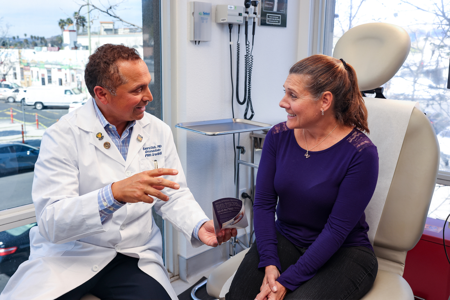 Palomar Health doctor talking with a patient in a San Diego hospital