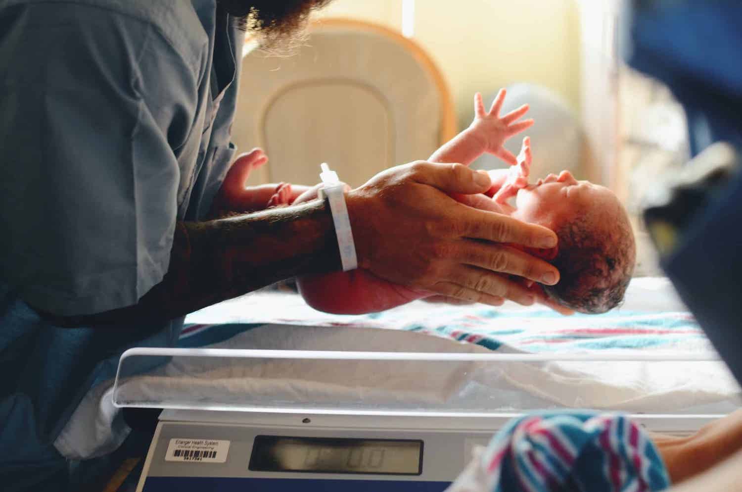 Rady Children's Hospital in San Diego featuring a nurse holding a newborn as part of the Begin NGS genome sequencing study