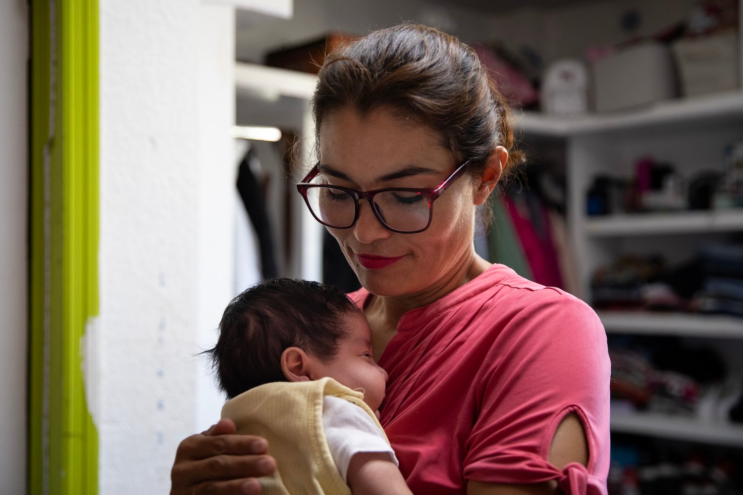 Juana Ortiz holds a two-month-old baby who could possibly have HIV at EUNIME Por Tijuana orphanage on in Tijuana, Mexico