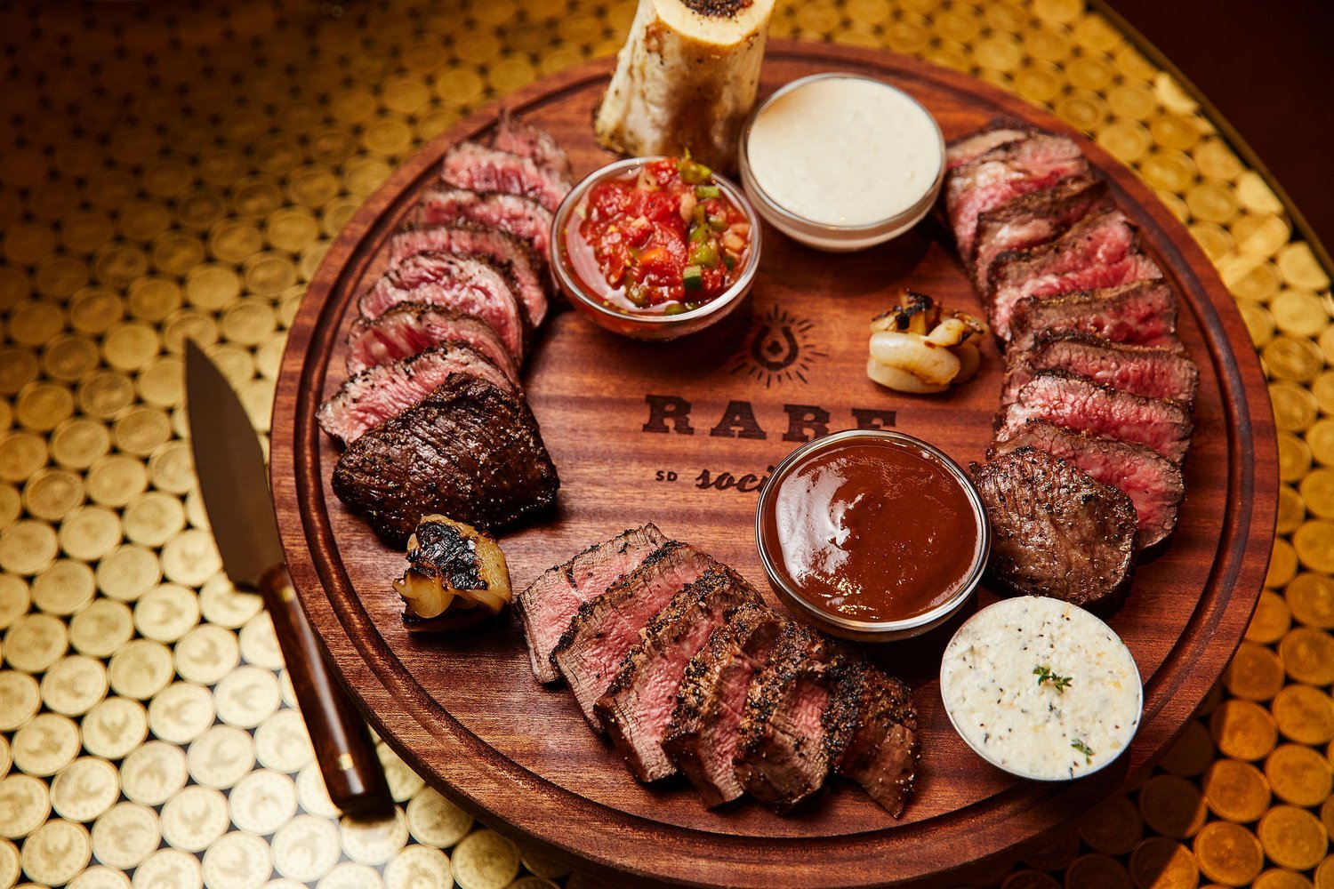 Best San Diego steak restaurants featuring a cut of meat on a  cutting board from Rare Society in University Heights