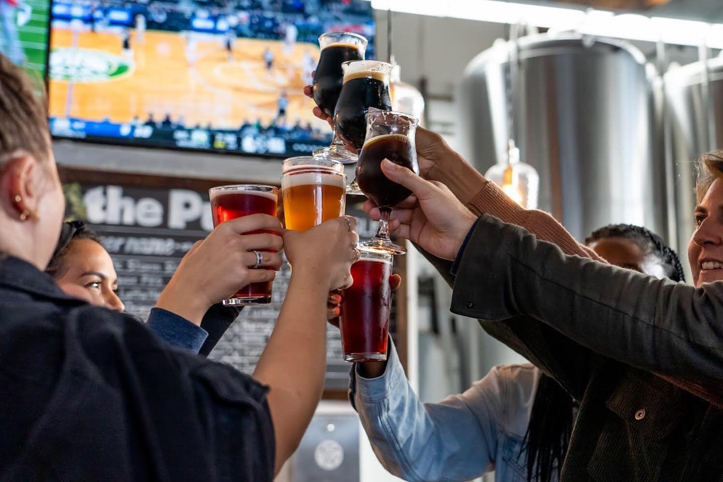 People clinking beer glasses together at the 2024 San Diego Beer week happening Nov. 1 - 10