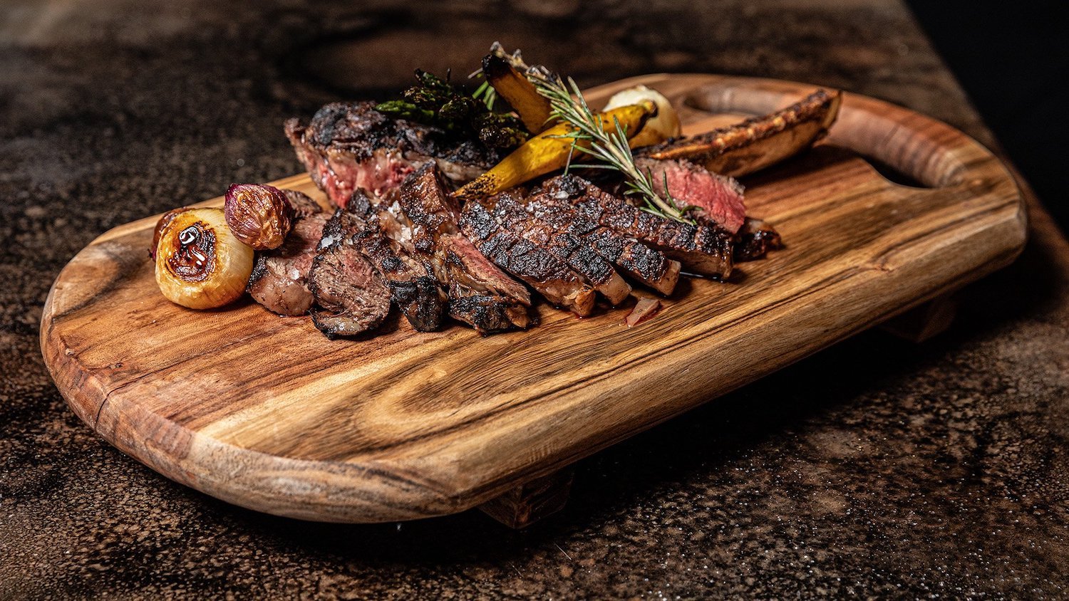 Best San Diego steak restaurants featuring sliced meat on a cutting board from The Remy in Mission Valley