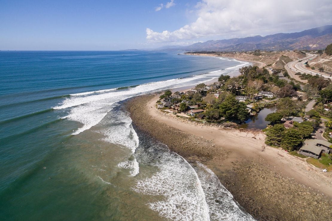 Best California surf spots featuring aerial view of Rincon Point point break in Santa Barbara