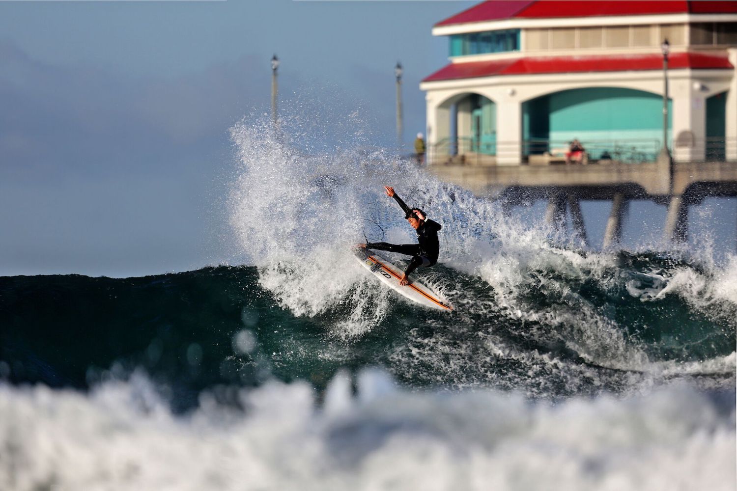 Best California surf spots featuring a surfer at Huntinton Beach Pier 