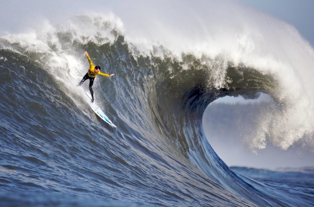 Best California surf spots featuring a big wave surfer at Mavericks at Half Moon Bay