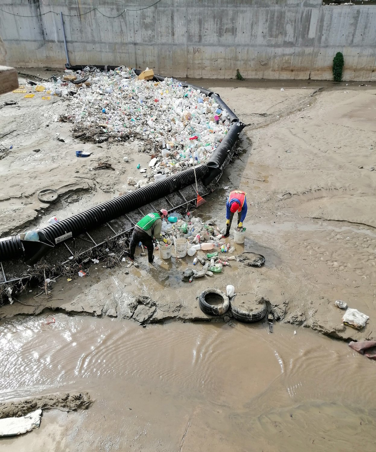 A trash boom in the Tijuana River where sewage is collected