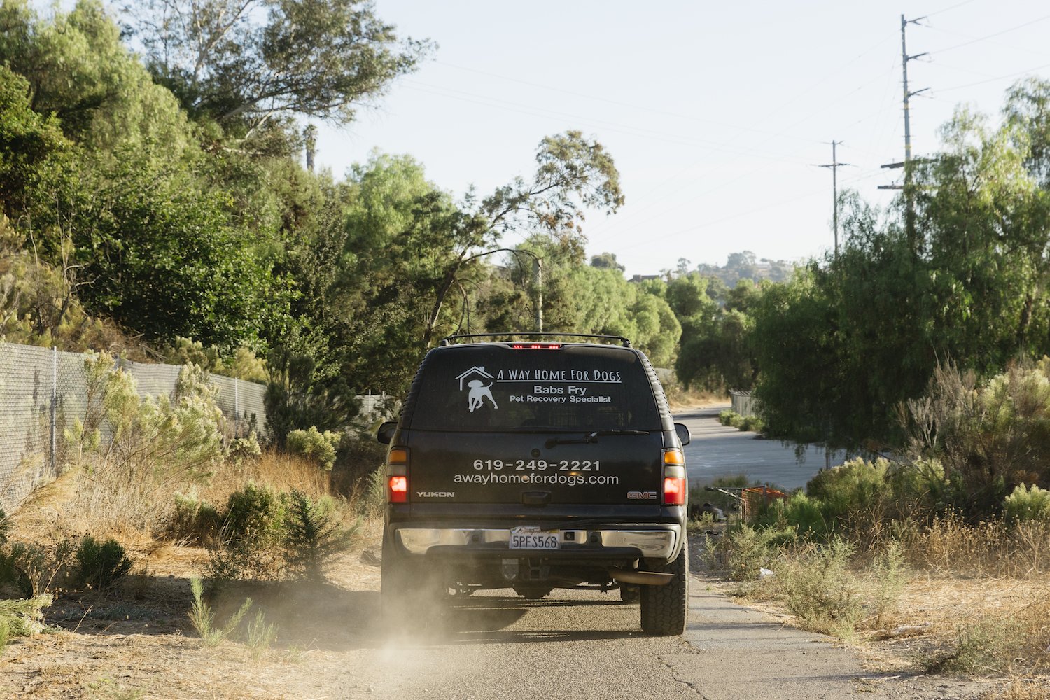 Babs Fry founder of San Diego nonprofit A Way Home For Dogs and her SUV featuring her contact info