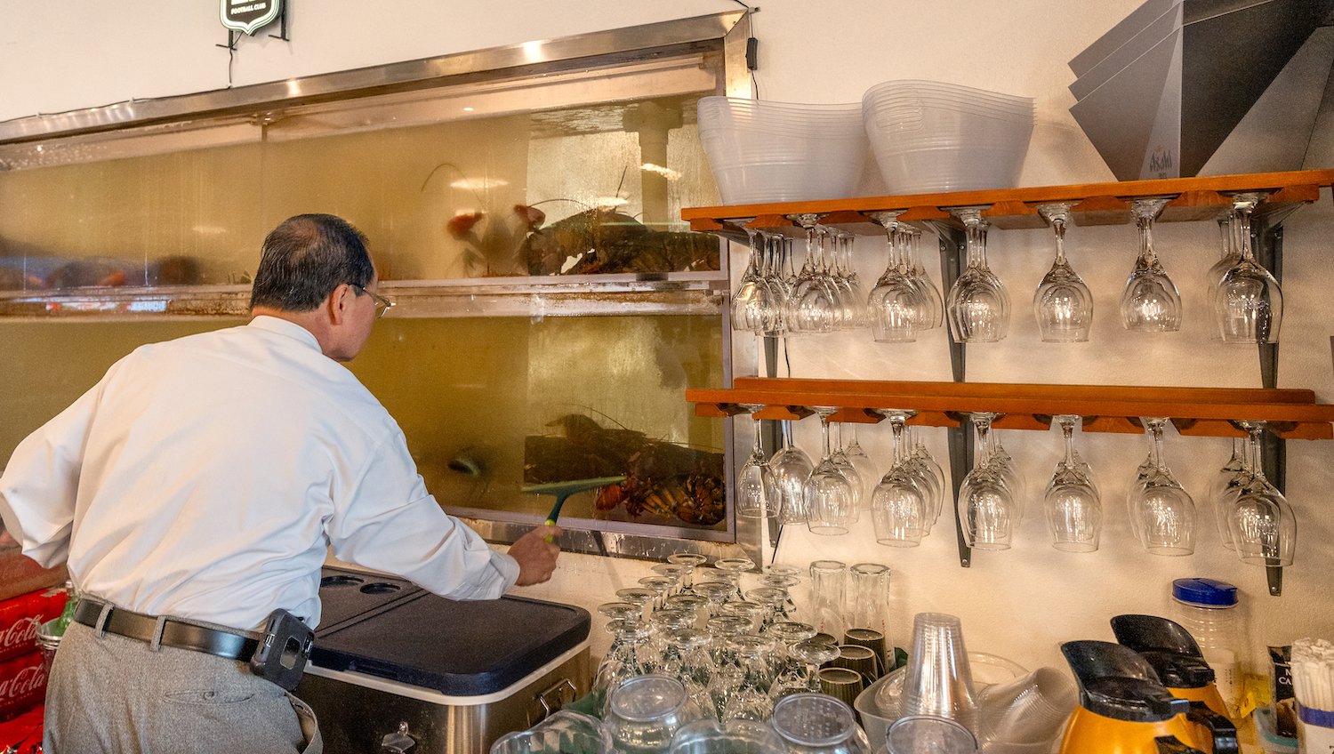 Dim Sum restaurant Diamond Palace owner Michael Tran cleaning a lobster tank