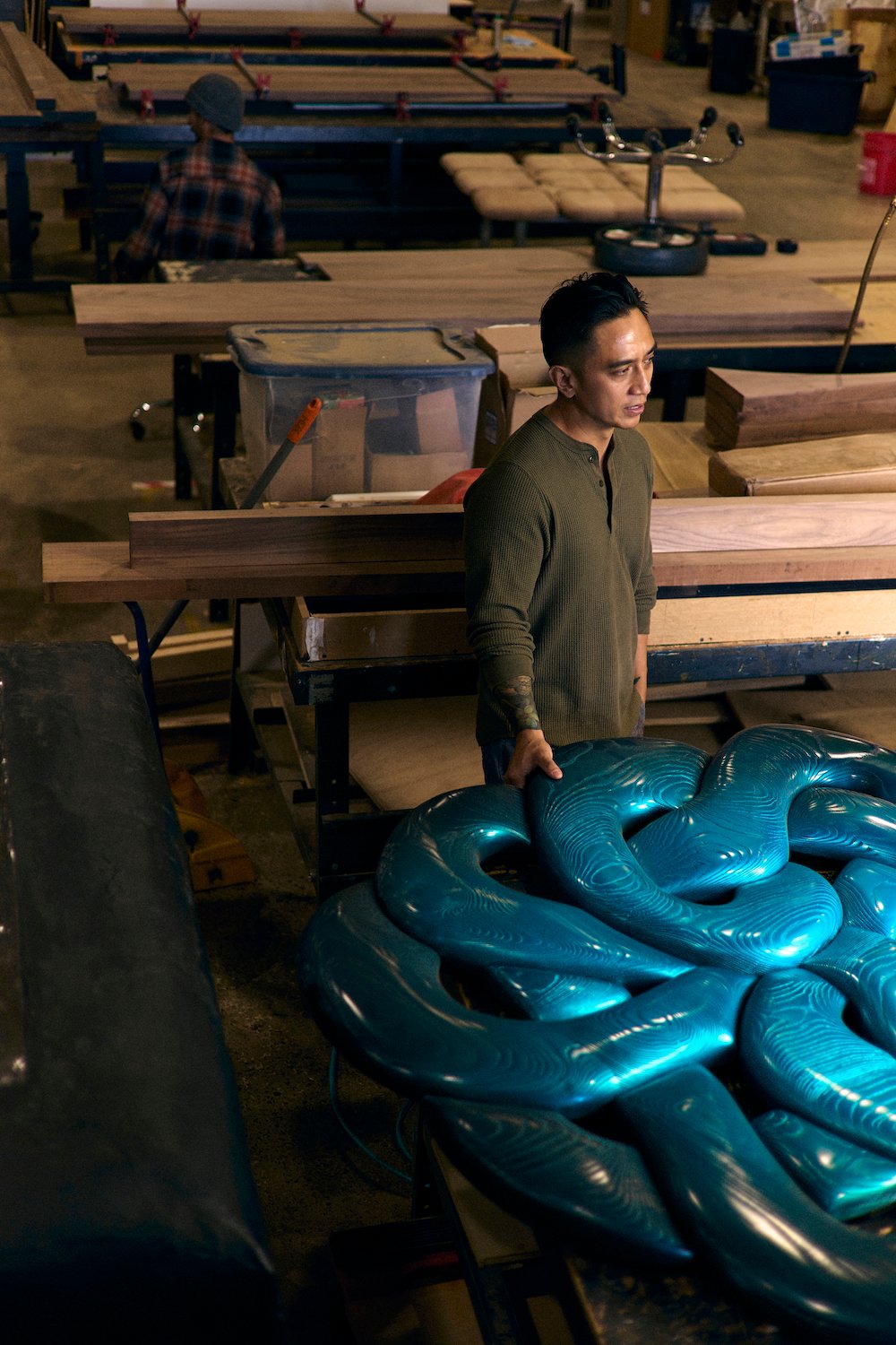 San Diego artists and wood sculptor Dan "Nuge" Nguyen in his workshop at Miramar's Maketory