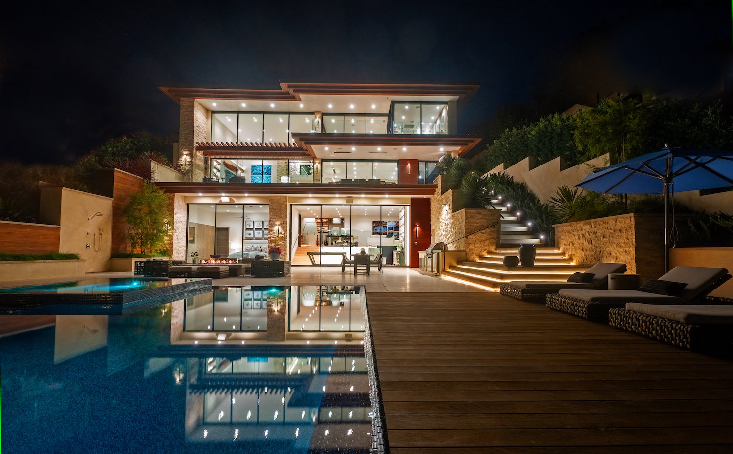 Exterior of luxurious Del Mar home owned by Kerry and Corrine Marsh featuring a pool, hot tub, and three levels of outdoor patio