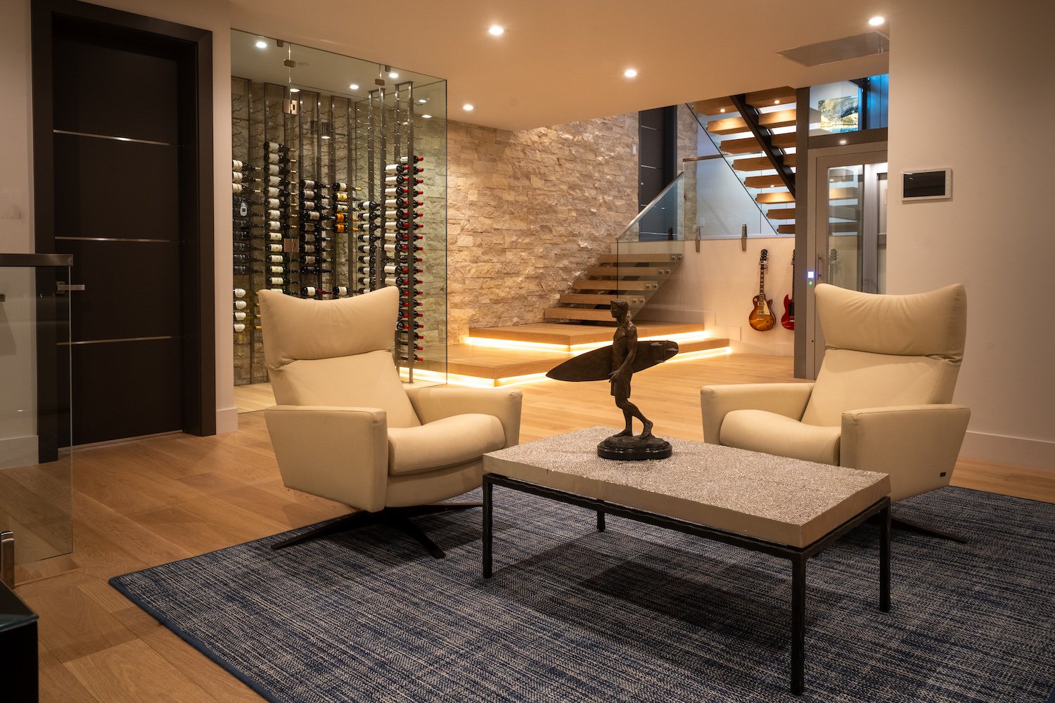 Interior of luxurious San Diego home in Del Mar owned by Kerry and Corrine Marsh featuring a wine cellar, guitars, and a statue of a surfer