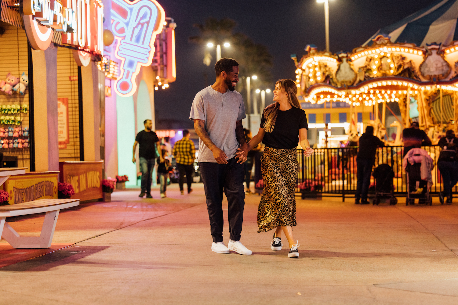 A couple on a date in San Diego at Belmont Park near Mission Beach