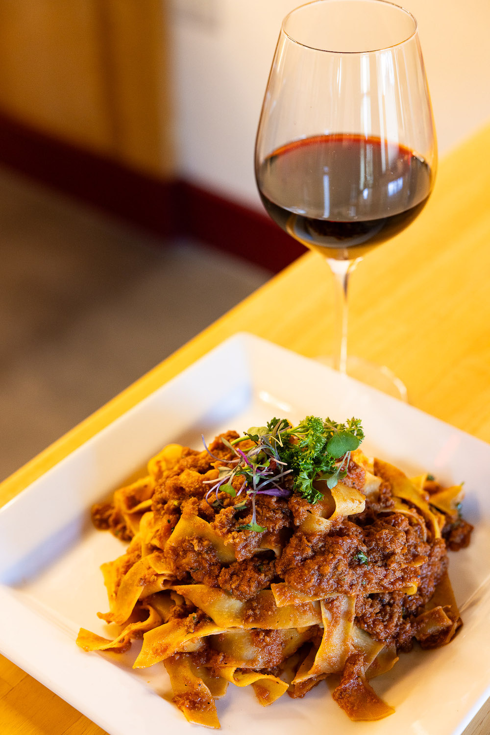 Pasta dish and wine from new San Diego Italian Restaurant Pezzi Del Mio Cuore opening in Point Loma