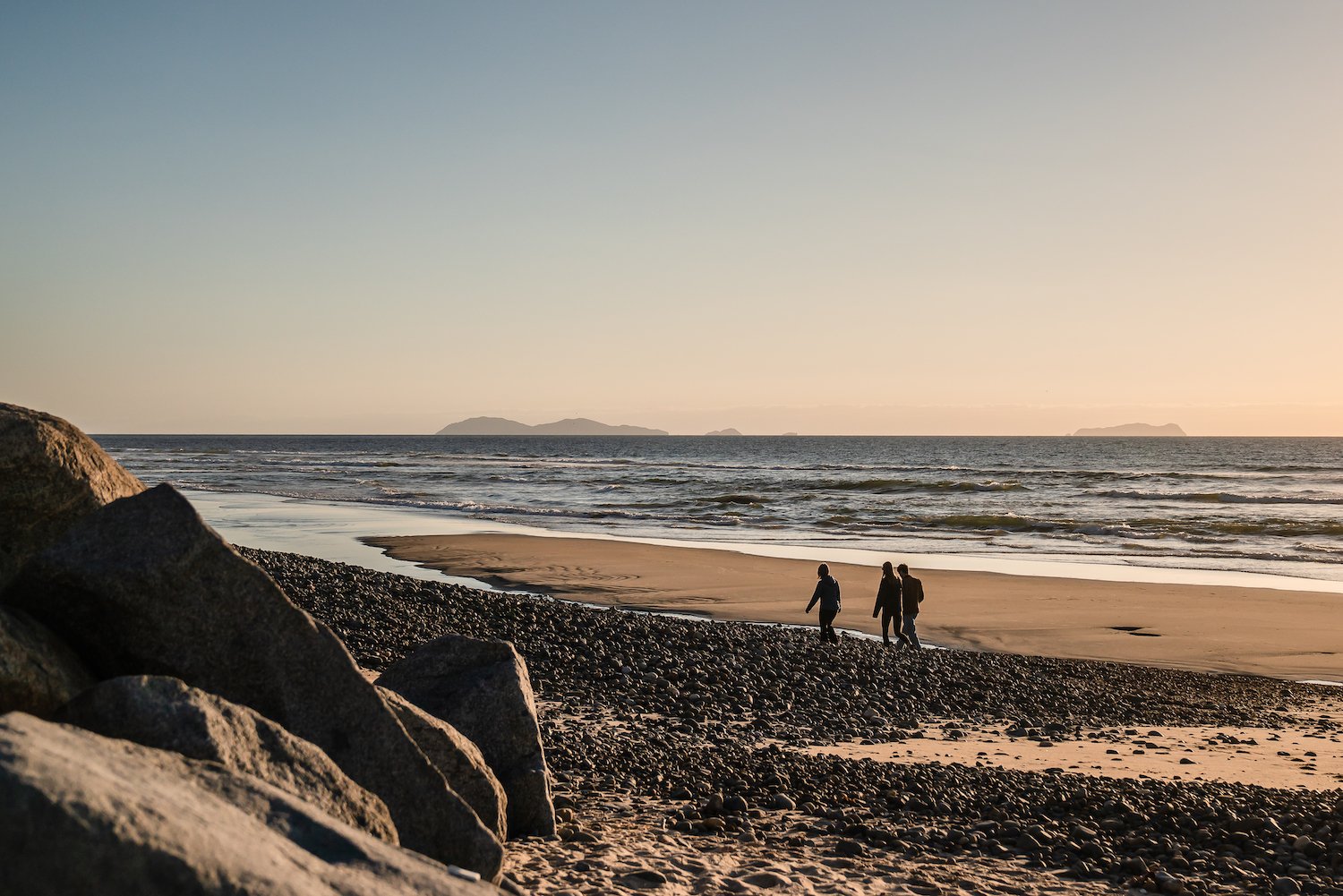 People walking on the beach in Imperial Beach, San Diego where the water is polluted