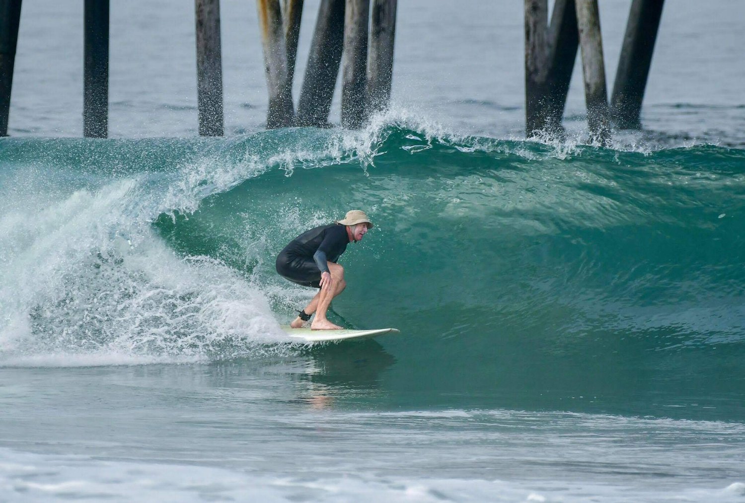 Former lifeguard and Imperial beach lifeguard Jeff Knox surfing at Imperial Beach Pier despite pollution