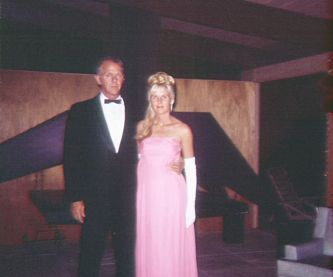 Becky and Bill Ivans in front of the iconic fireplace