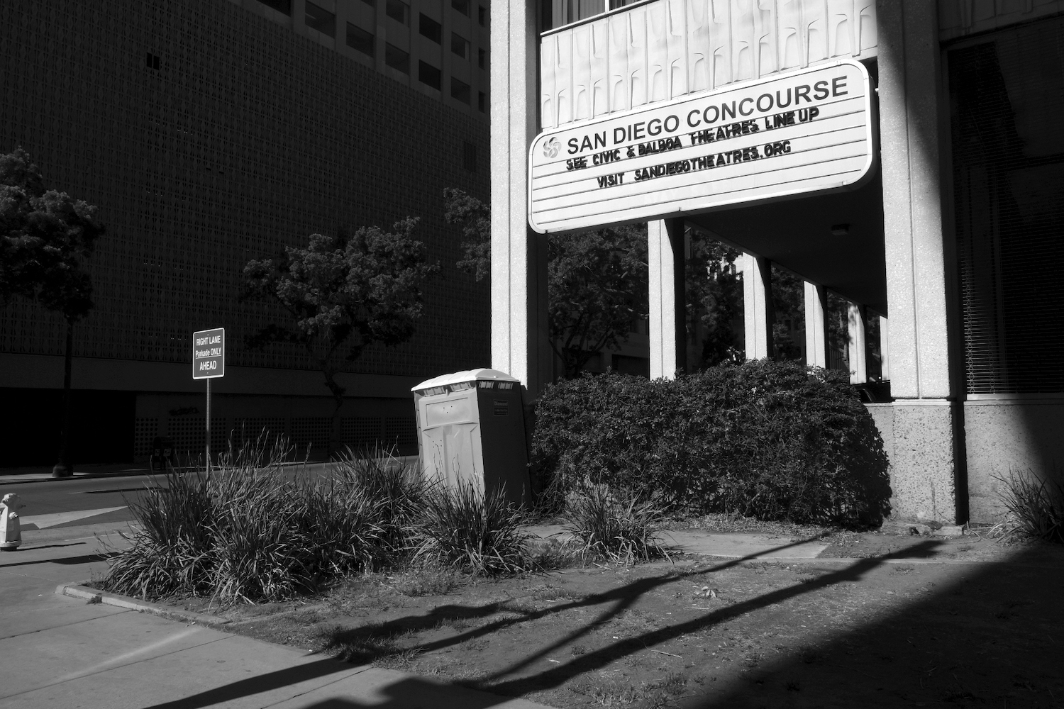 Downtown San Diego's Civic Theatre featuring a porta potty in the foreground