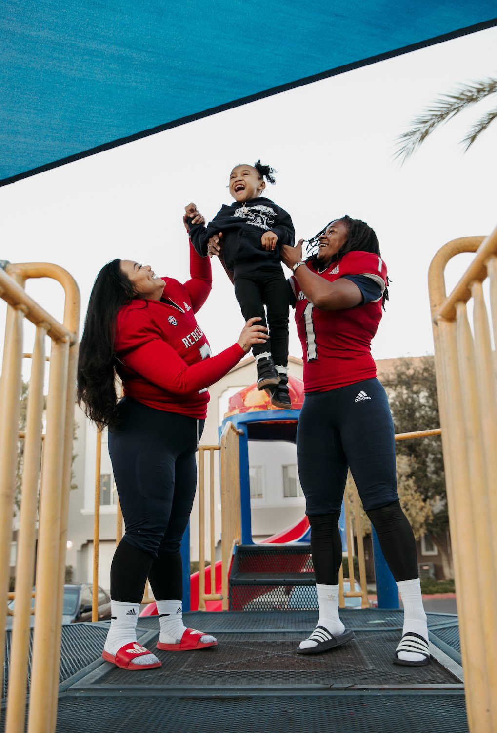 San Diego Rebellion women's football players Joann Mamuyac and Brittani Lusain with their daughter