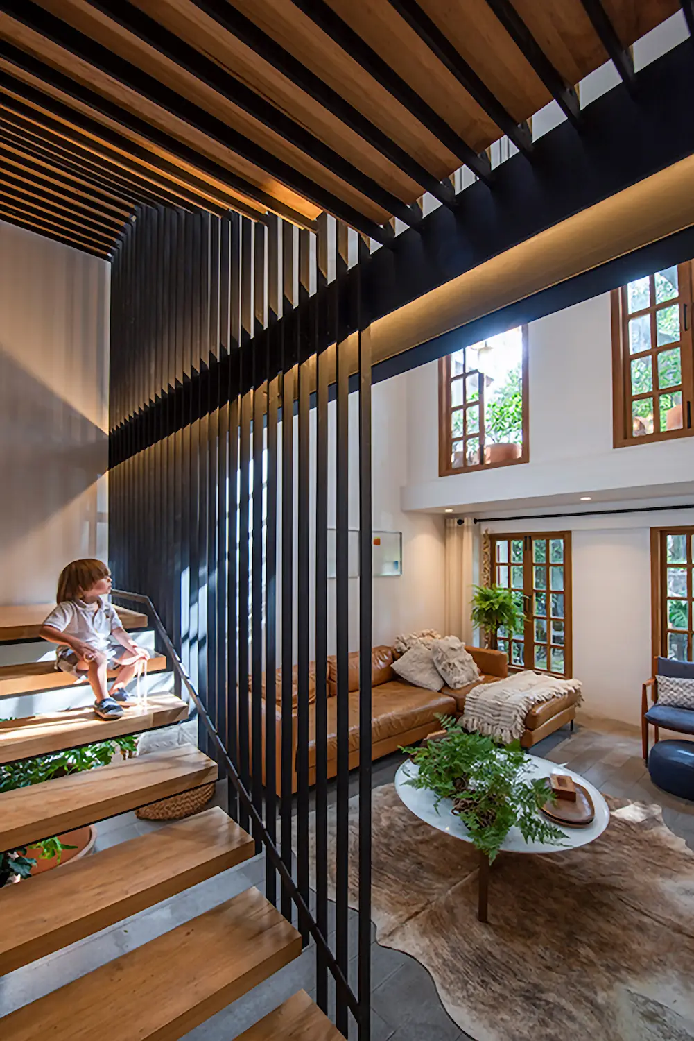 Interior stairs and living room of Mexico City modern architect home owned by Rosa Agraz and Alejandro Solís in San Ángel