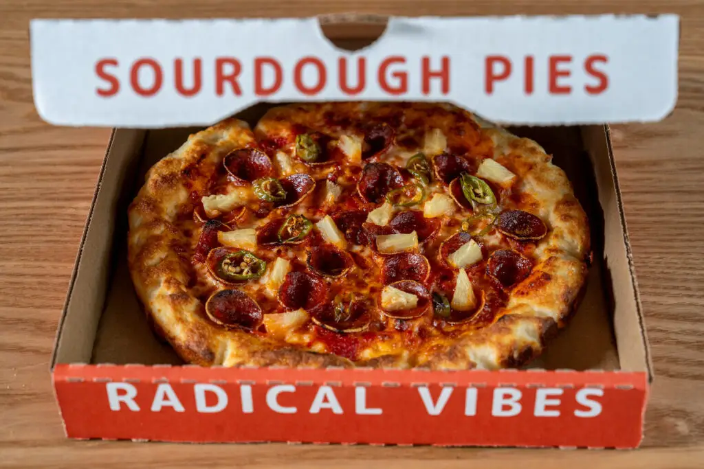 New San Diego pizza restaurant Odie's Pizza opening in Oceanside featuring a delivery pepperoni and pineapple pizza