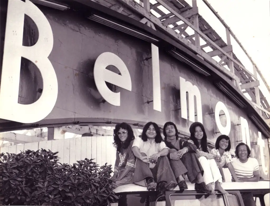 Historical photo of San Diego's Belmont Park featuring teens near the park's sign 