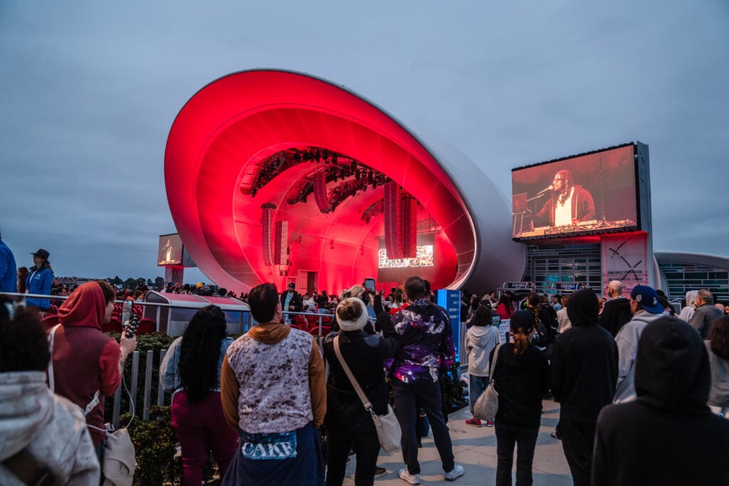 Fans a the Rady Shell at Jacobs Park watching a Ludacris concert from outside the gates for free