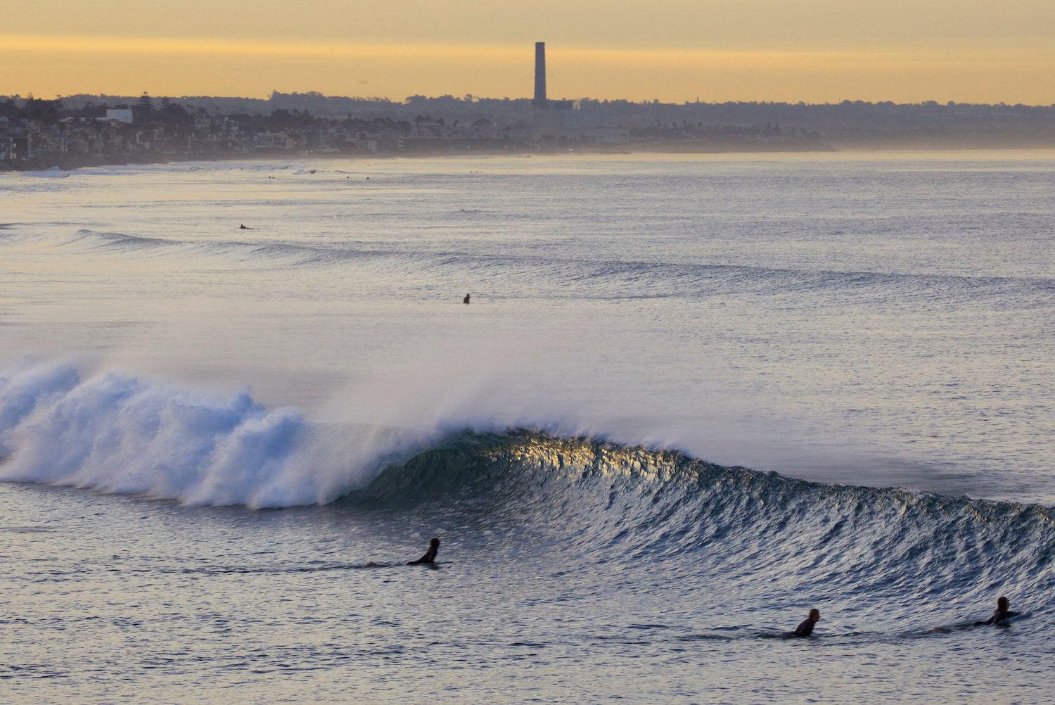 Surfers in Oceanside, San Diego paddling out