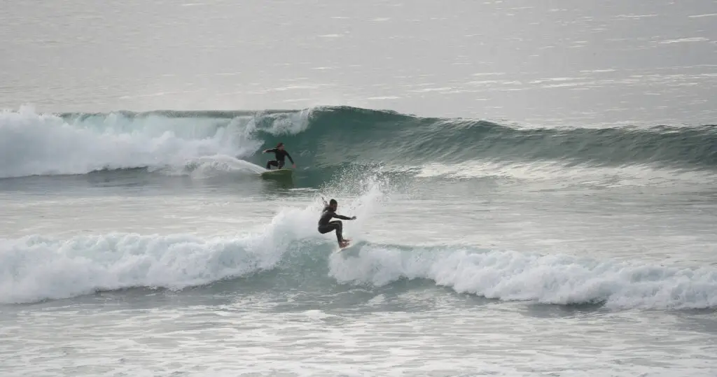 Surfers riding waves at Scripps Pier and La Jolla Shores
