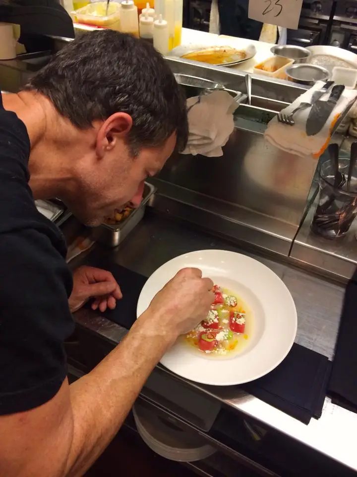 Chef Carl Schroeder making food at San Diego Michelin-recognized restaurant Market Restaurant + Bar in Del Mar