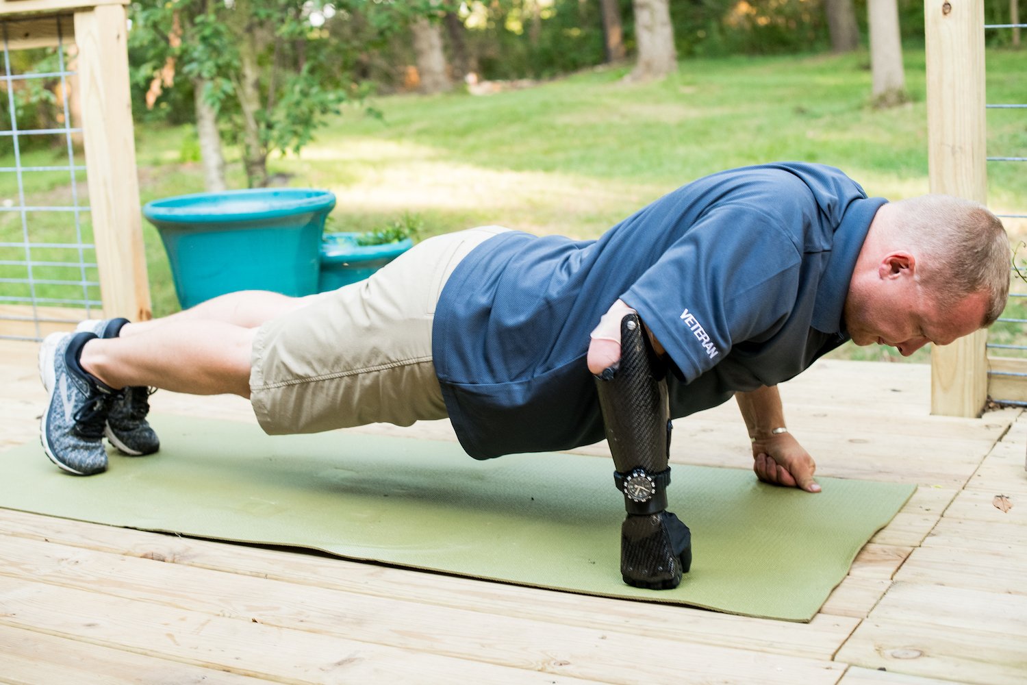 A man with Psyonic's ability hand bionic doing a pushup