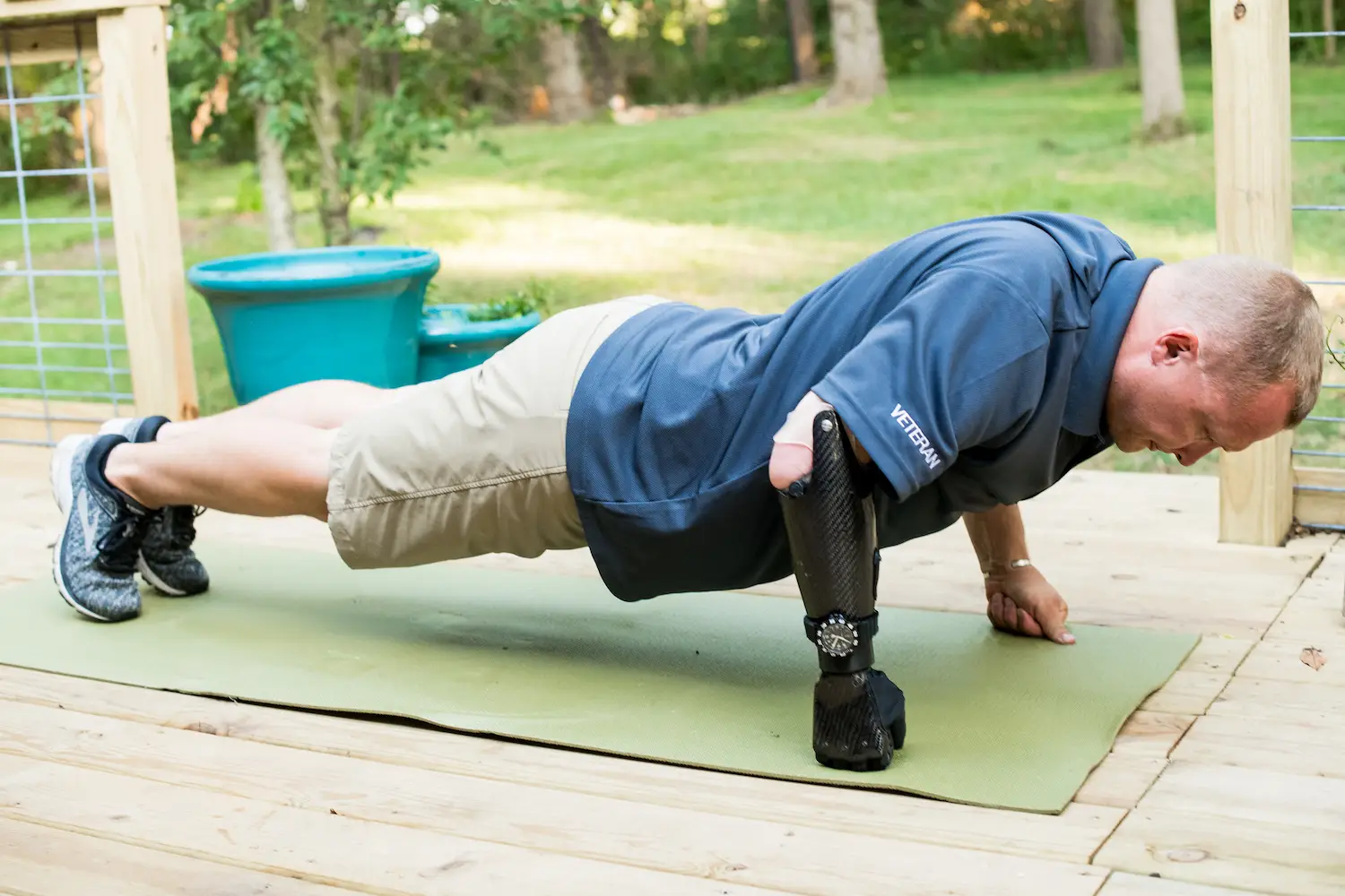 A man with Psyonic's ability hand bionic doing a pushup