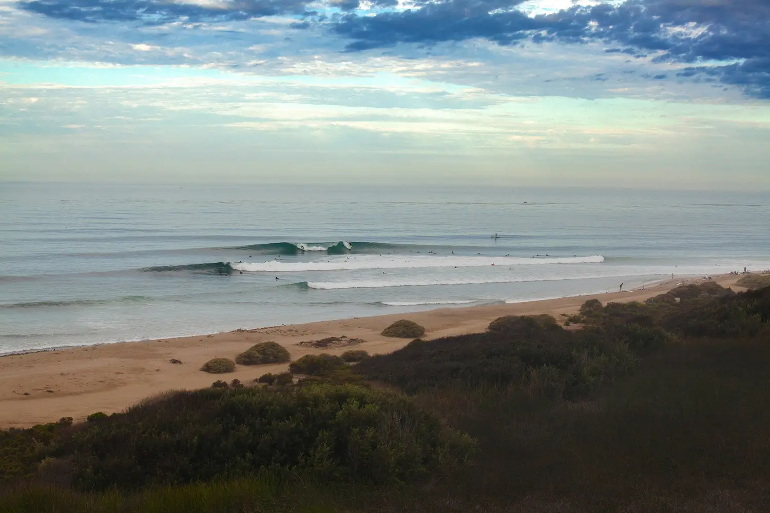 Surfers riding waves at Trestles surf spot near San Diego 