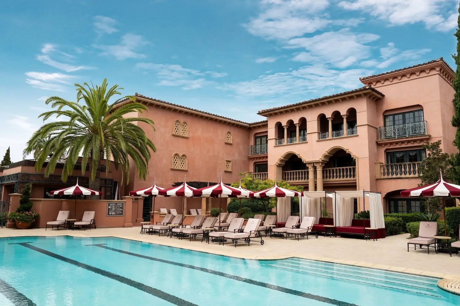 Exterior of San Diego luxury hotel Fairmont Grand Del Mar featuring a pool area