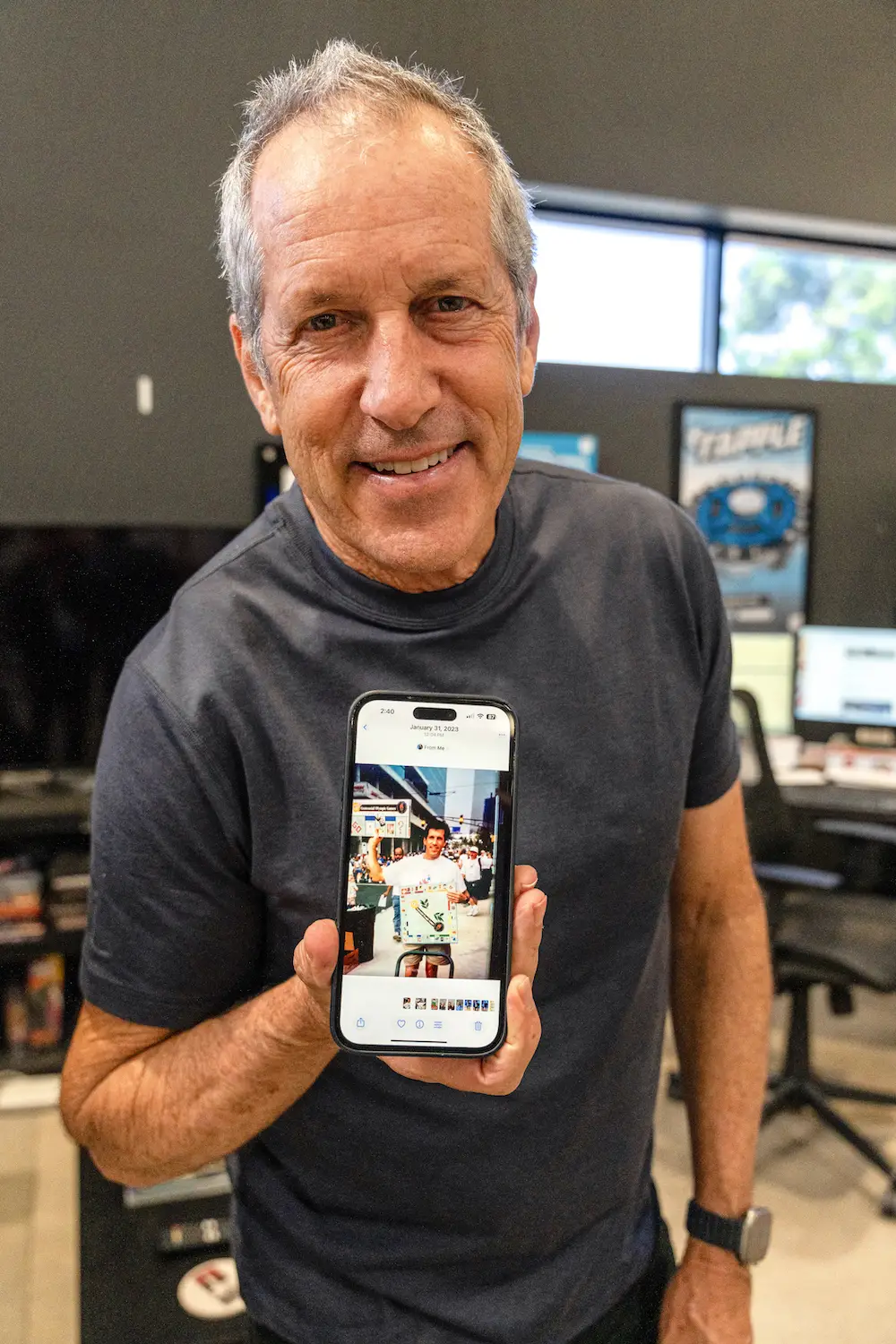 Dane Chapin founder and CEO of San Diego board game company USAopoly and The Op Games in Carlsbad holding up a picture of him selling Monopoly games at the 1996 Atlanta Olympics